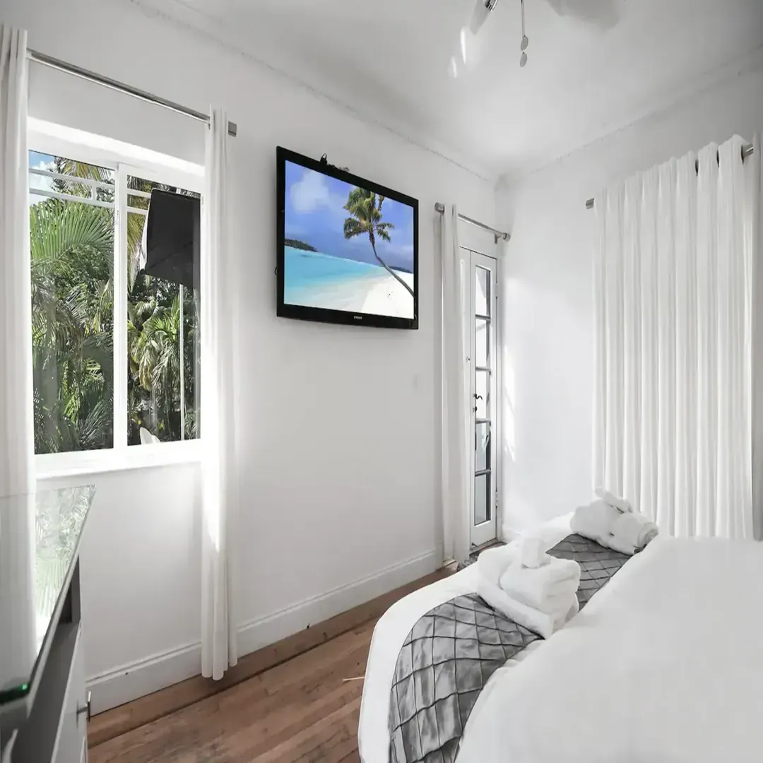 En-suite with balcony and 50-inch smart TV at Villa Laurell Estate Miami home rental