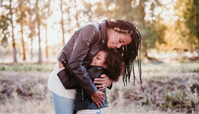 A mother and daughter hugging in gratitude.