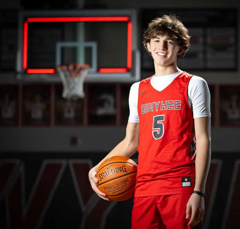 owyhee high school varsity basketball player holding ball on hip