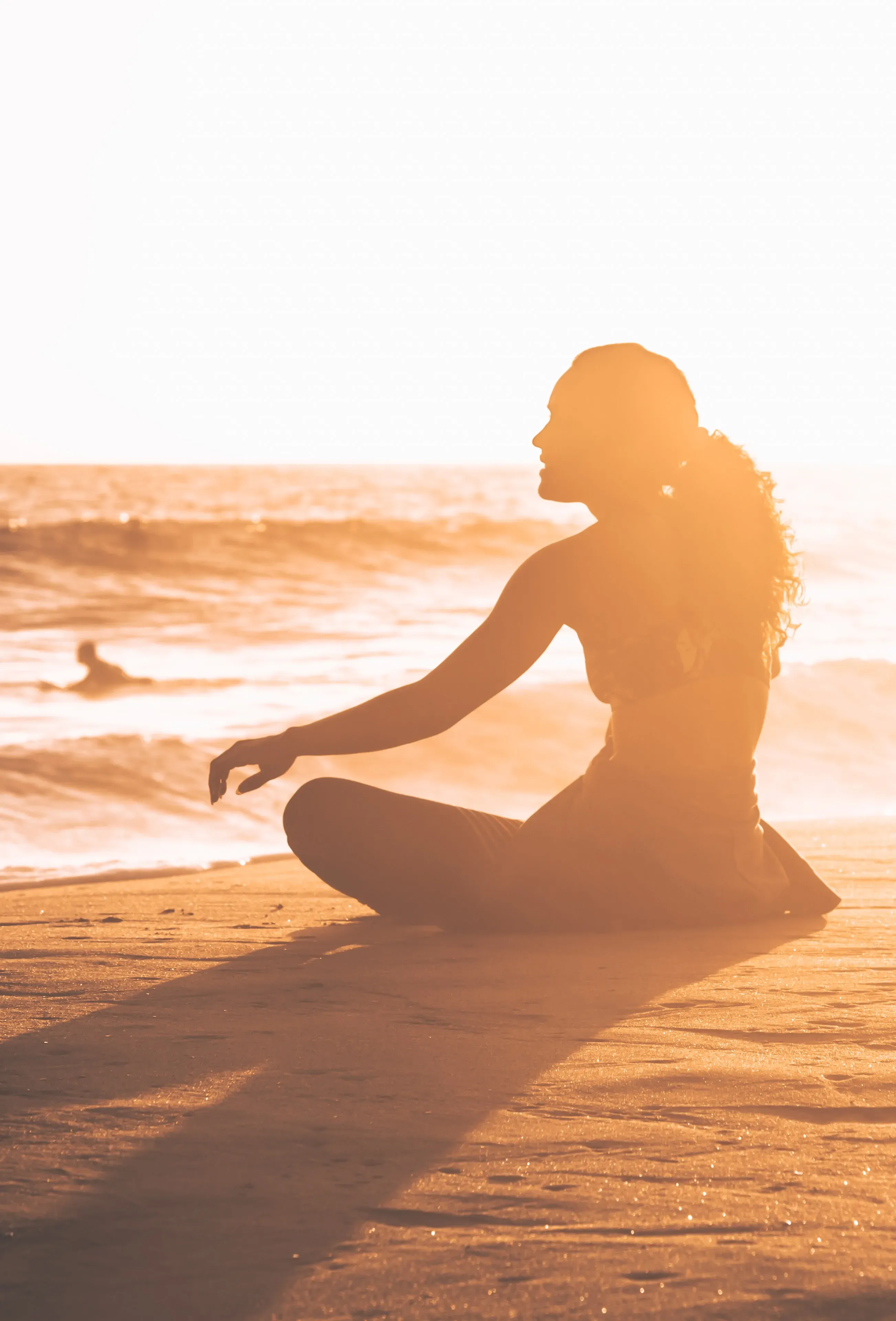 Picture of woman meditating on sunset beach