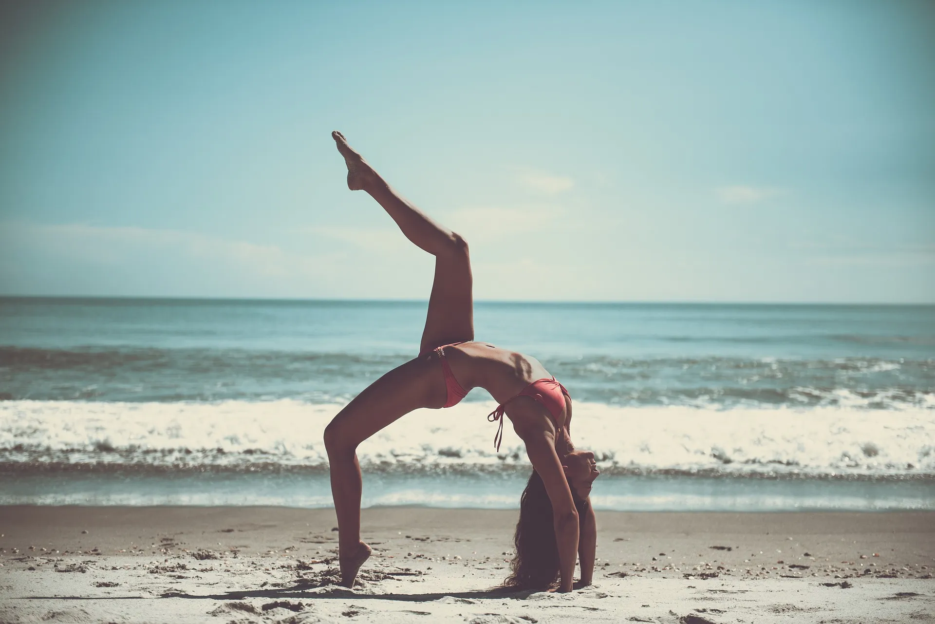 Yoga pose on the beach seeking balance