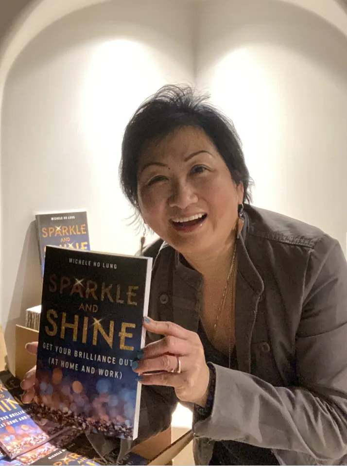 Michele holding up Sparkle and Shine Bok