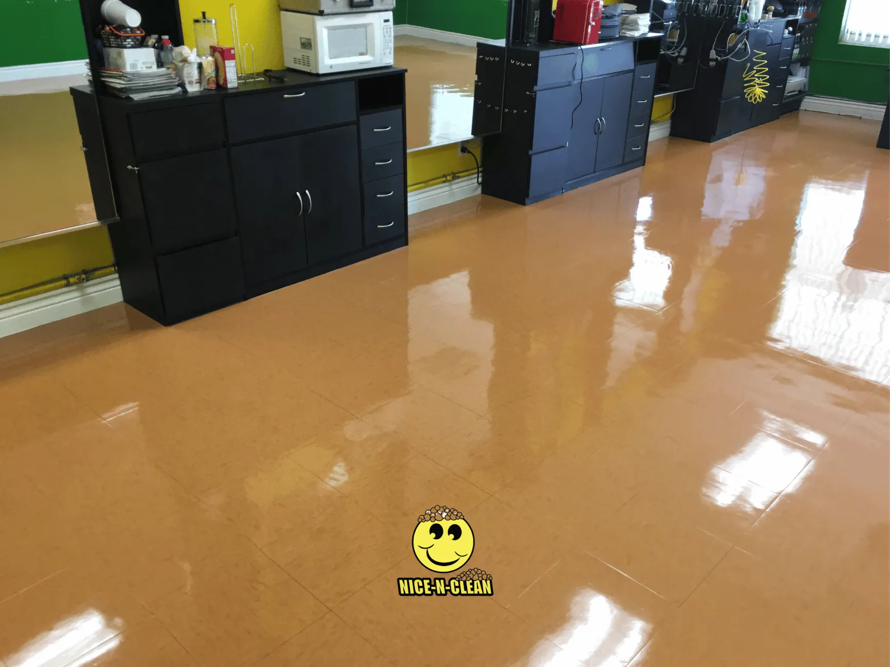 Shiny orange VCT floor at hairdressers after cleaning.