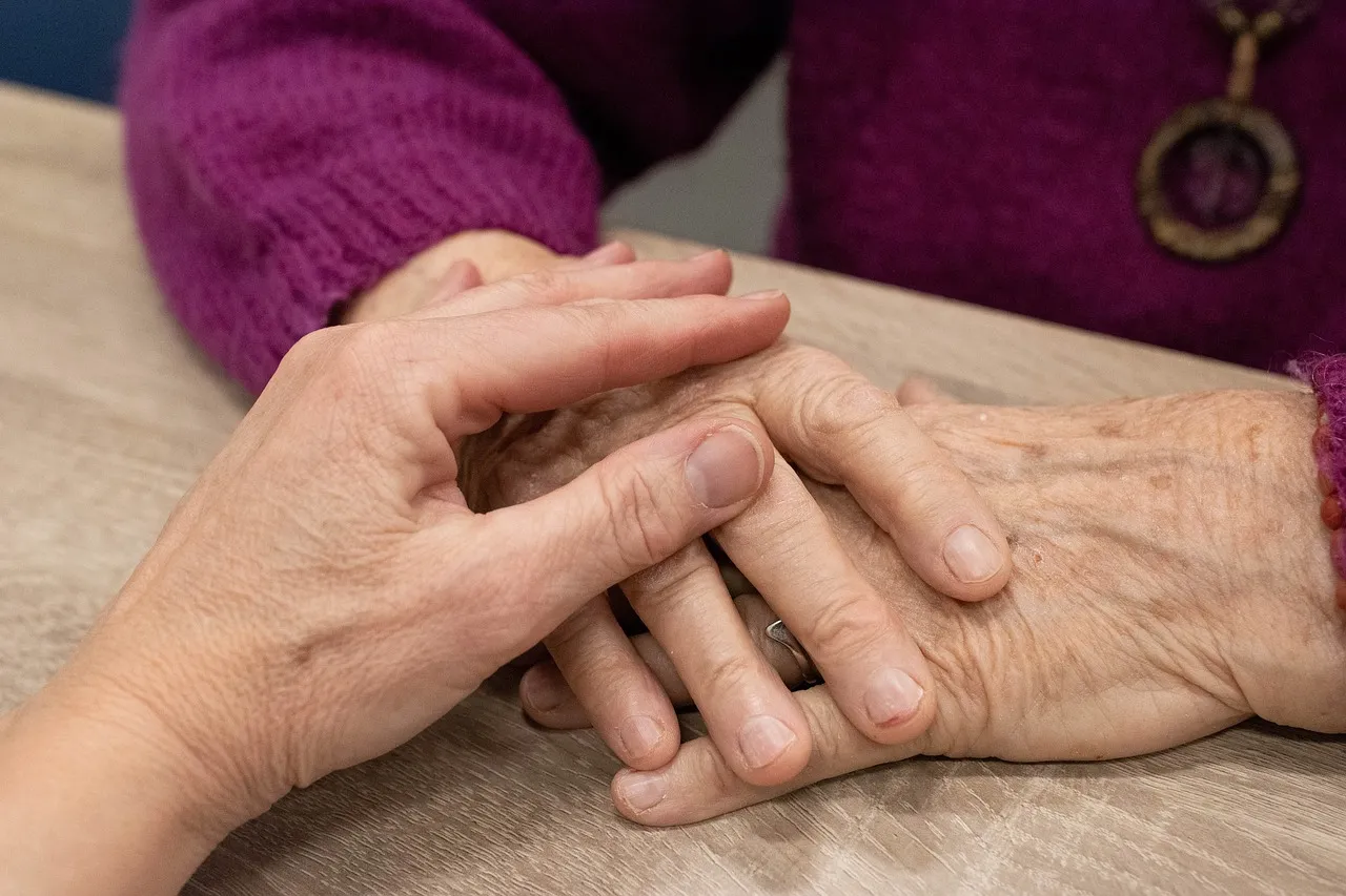 elderly lady holding hands