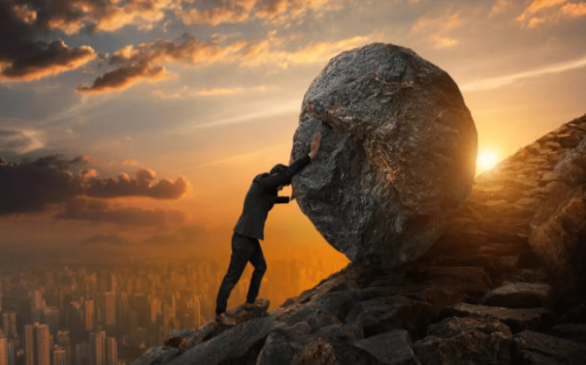 man pushing rock uphill