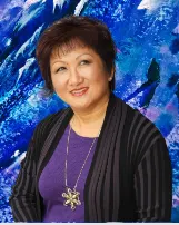 MIchele Ho Lung in Black jacket and white blouse with her right palm facing up. Smiling.