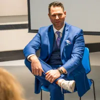Devin bisanz sitting calmly in front of an audience