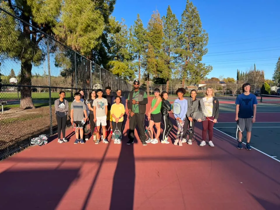 Youth Players attending tennis lessons with a coach