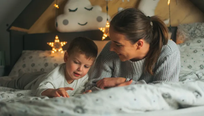 Mom reading with son before bed.