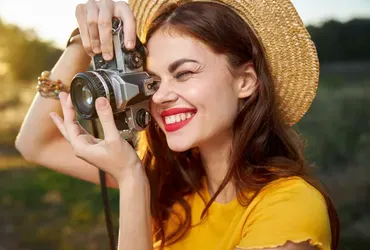 Woman in a hat taking a photo