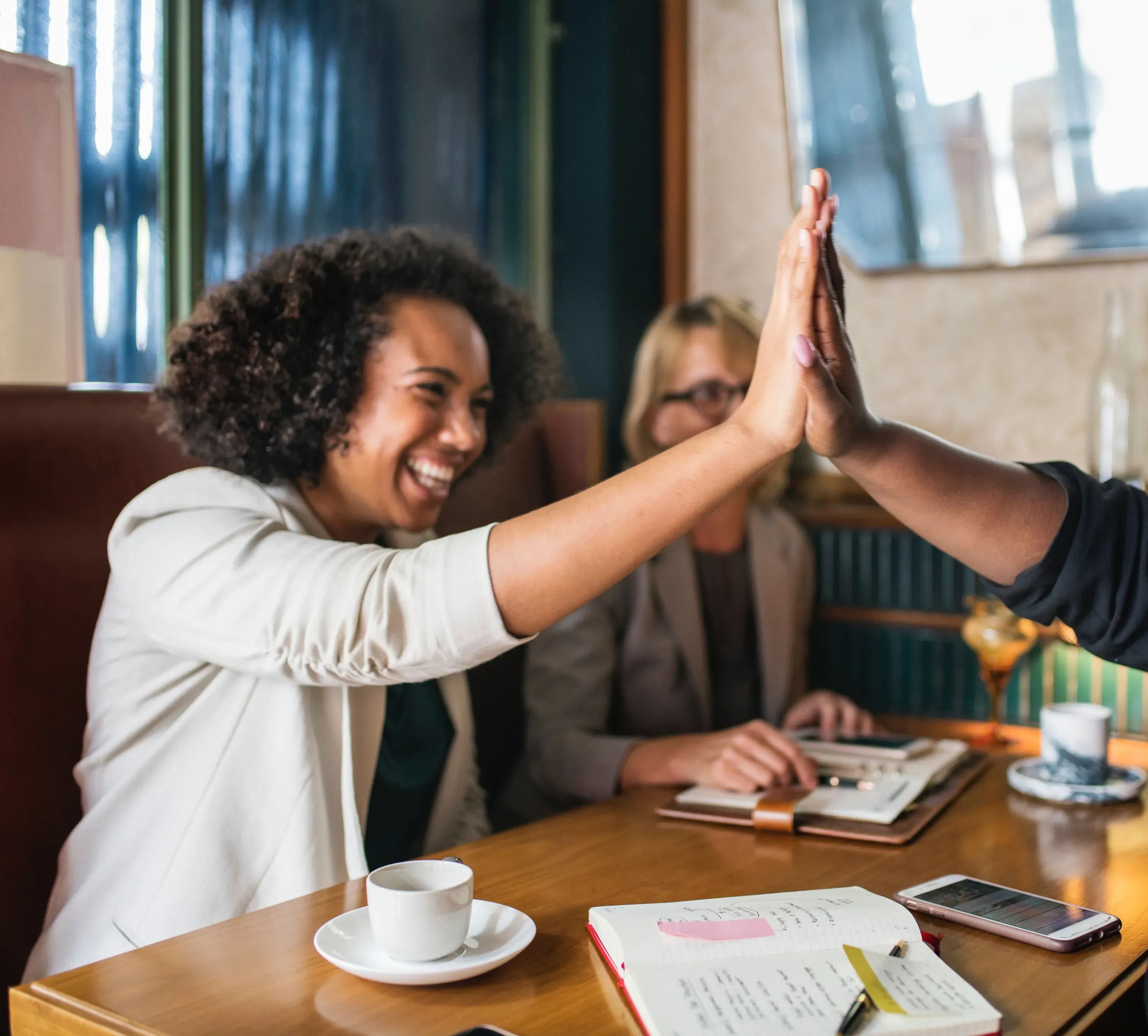 High five at a coffee meeting