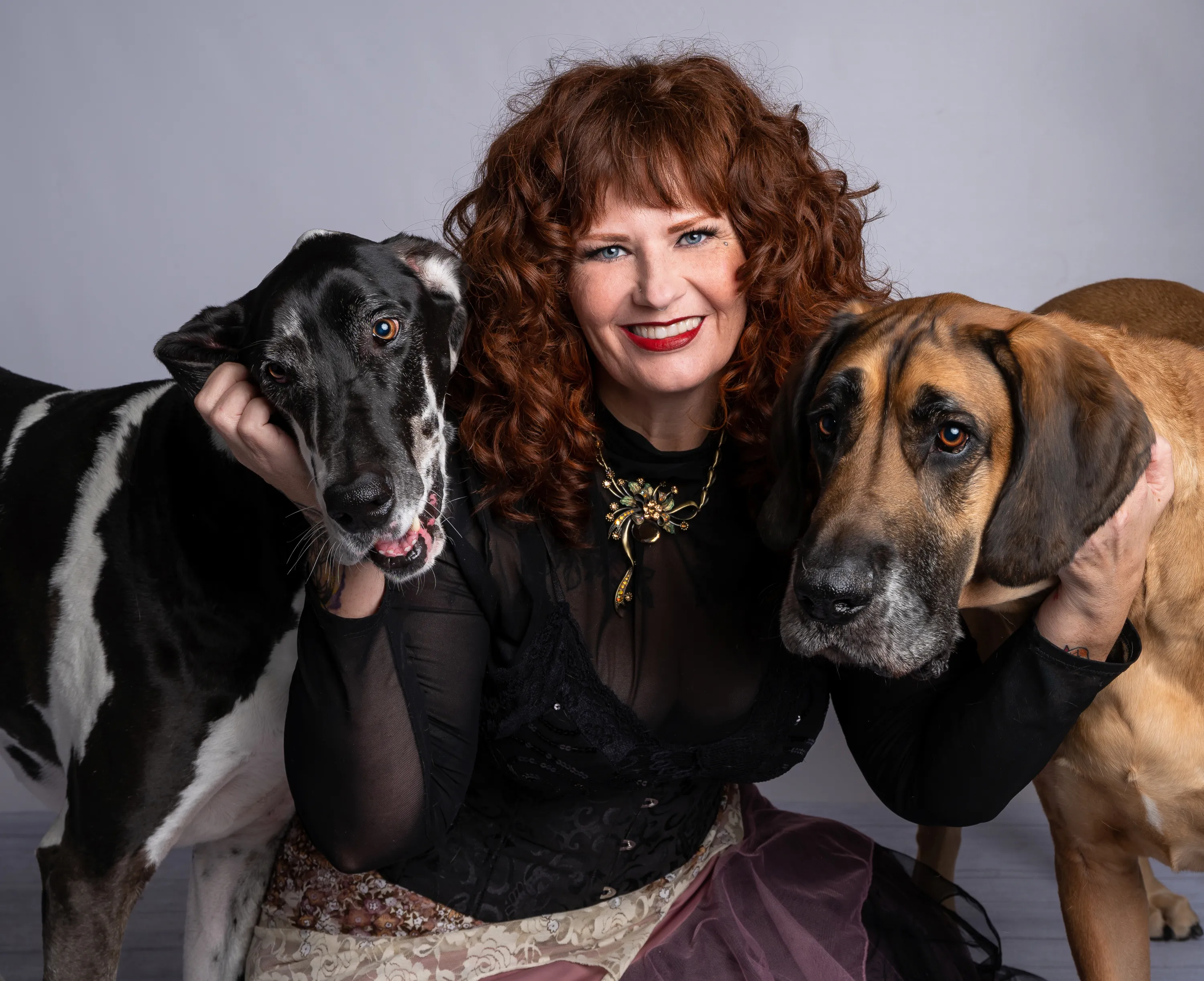redhaired woman with two large dogs