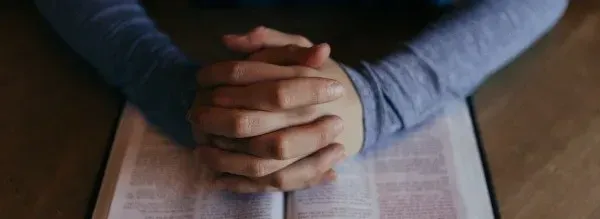 Man praying with a Bible