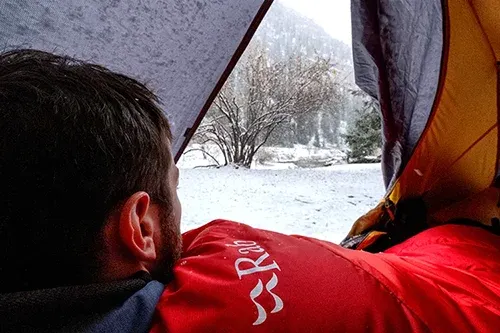 Hiking clothing layers and accessories laid out for a multi-day hiking and camping trip