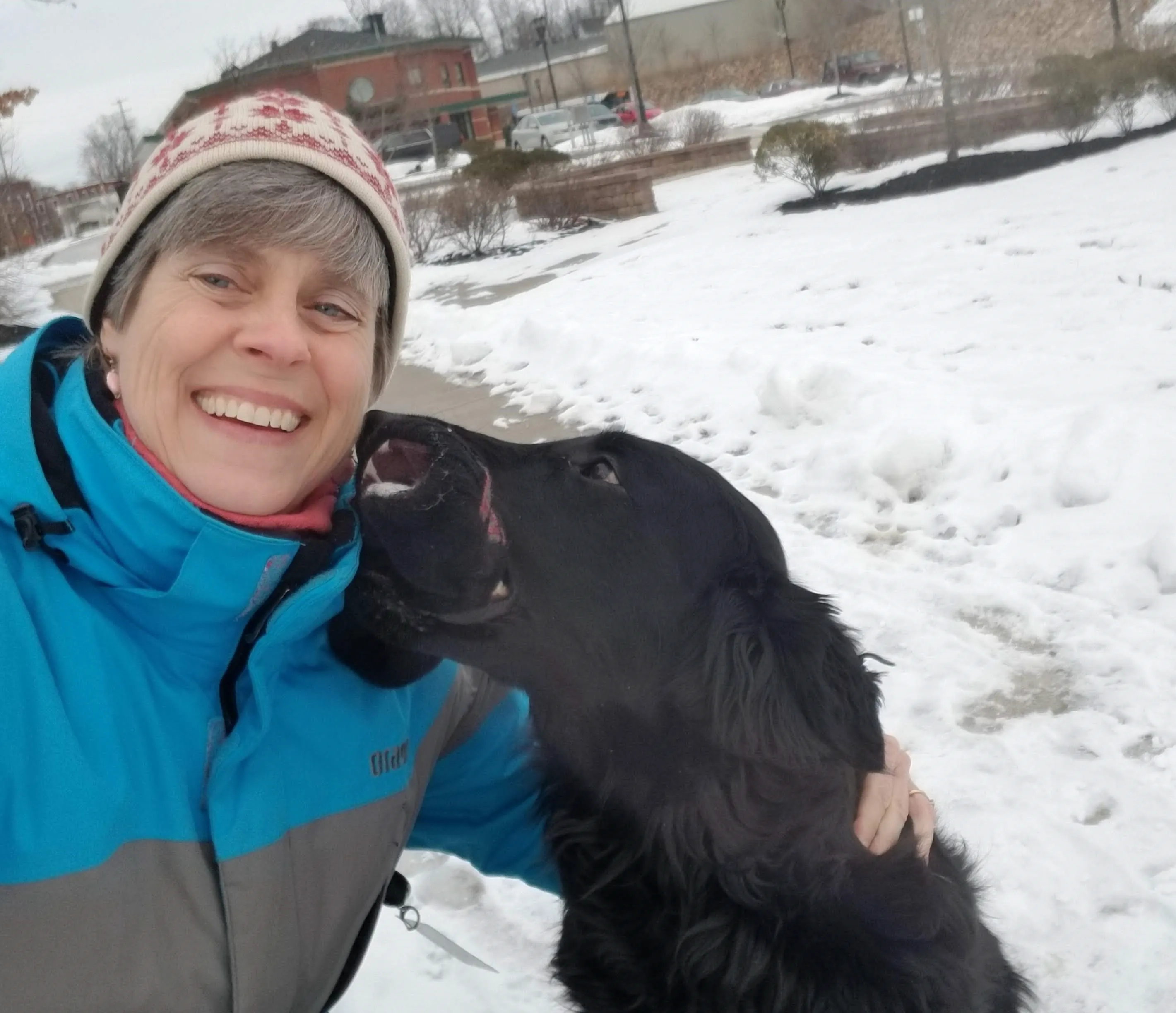 Deborah C. Owen and black dog in winter