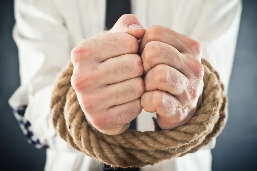 man with rope tied around his hands