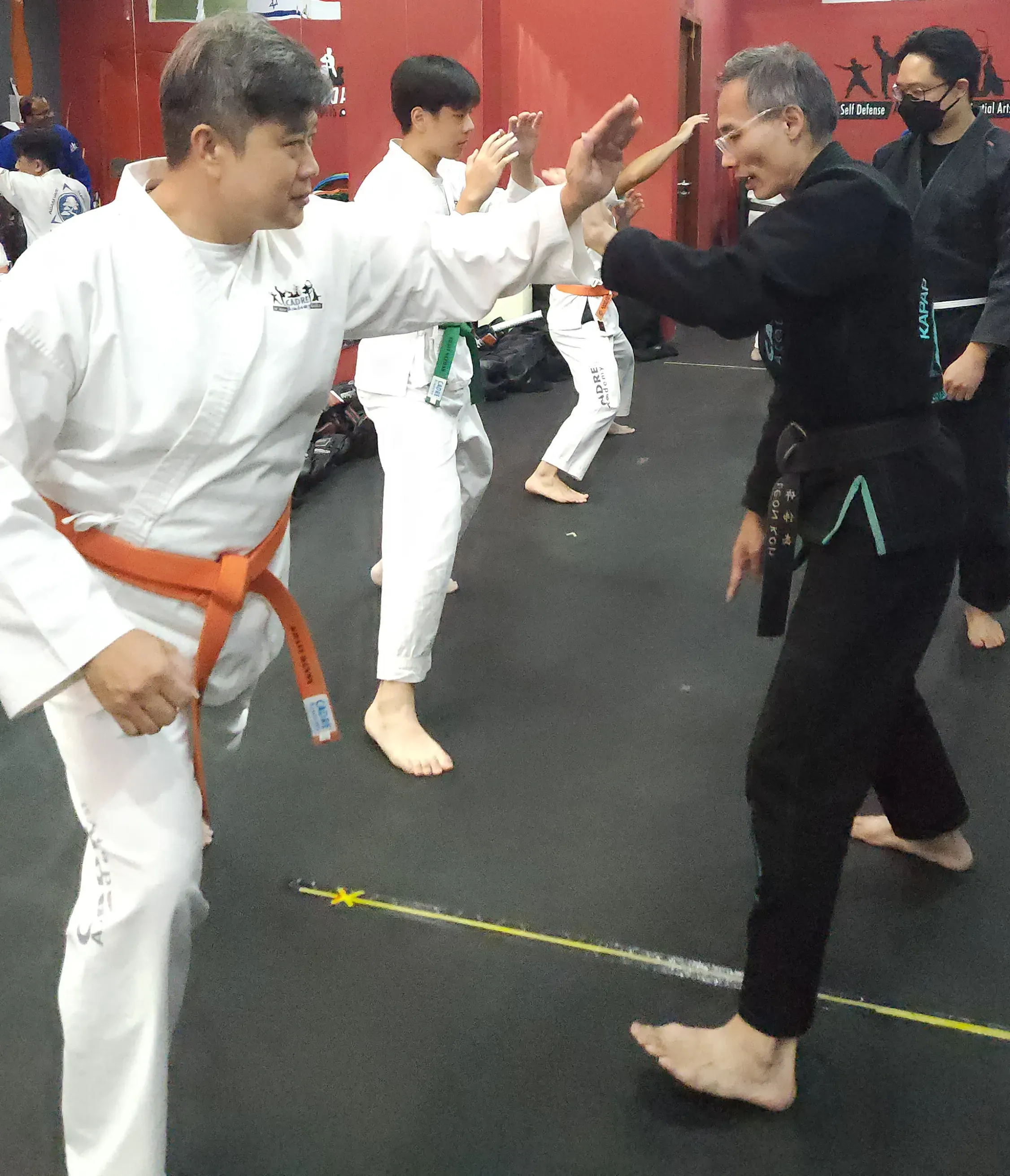 Leon Koh coaching a student during practical self-defence training at CADRE Academy Singapore