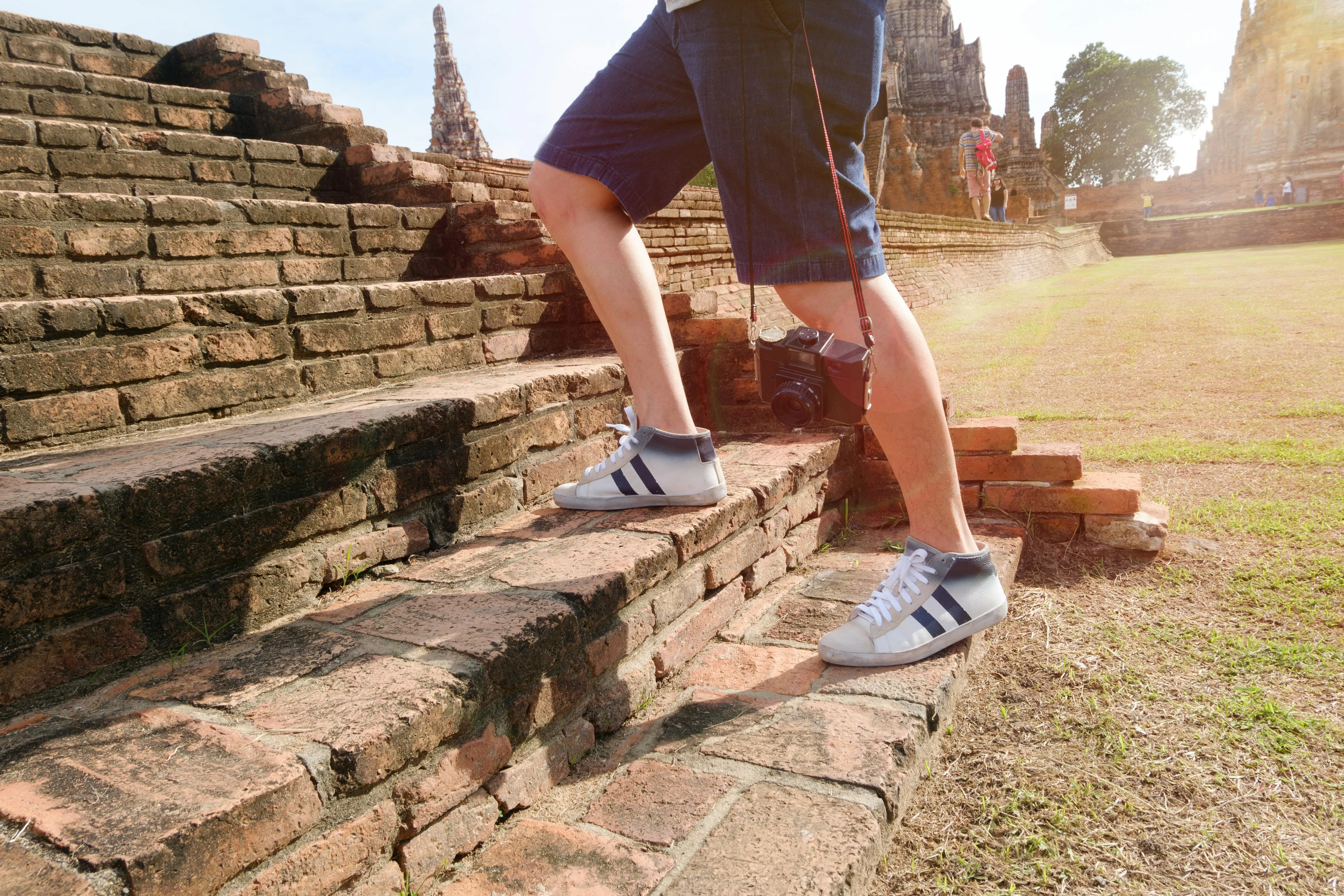 An individual climbing a staircase, shown from the ankle down, symbolizing step‑by‑step progress and disciplined ascent. The upward motion represents the structured build of a Proof‑of‑Work Ledger—each step reflecting a repeatable action, verified effort, and identity in motion.
