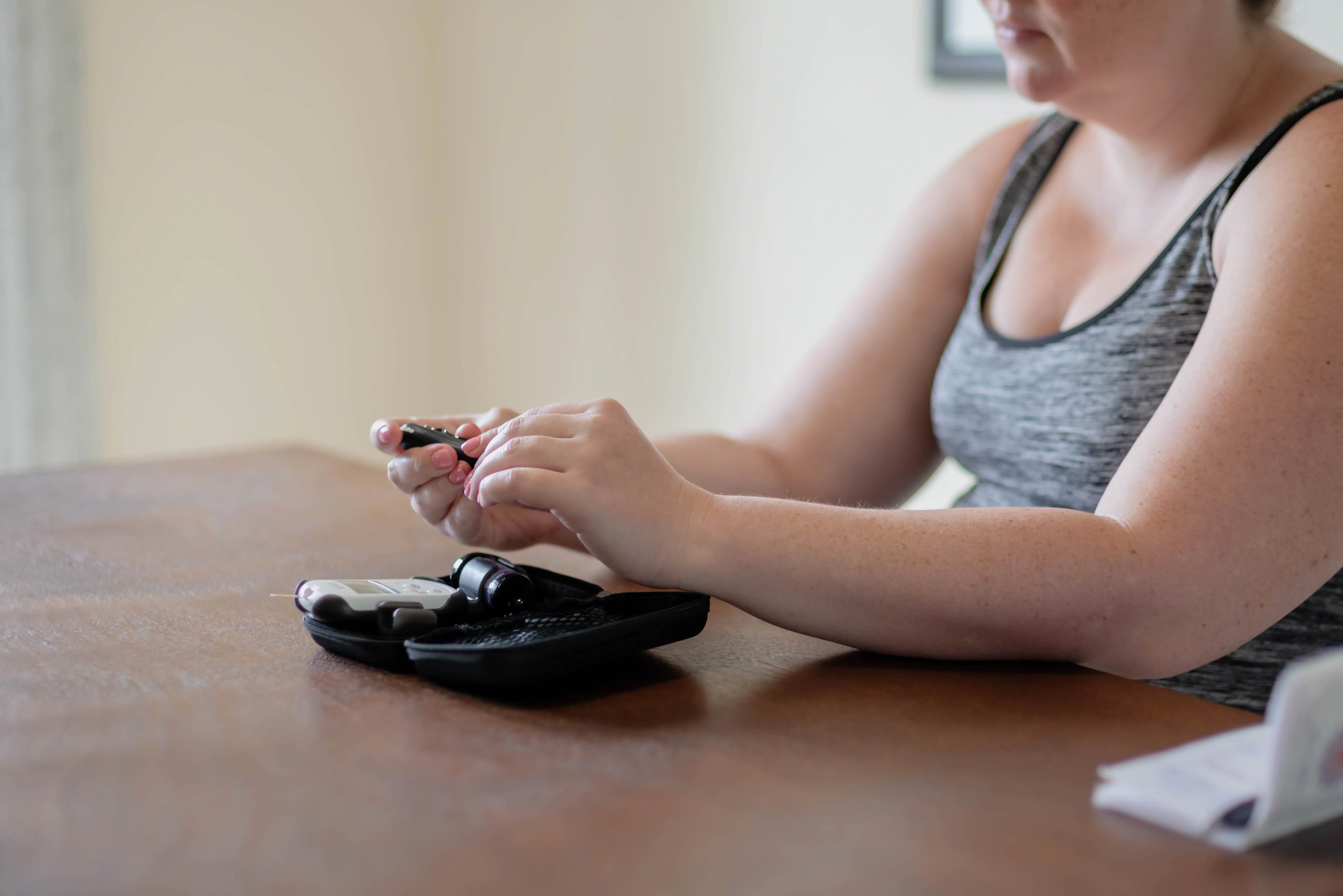 young woman testing blood sugar