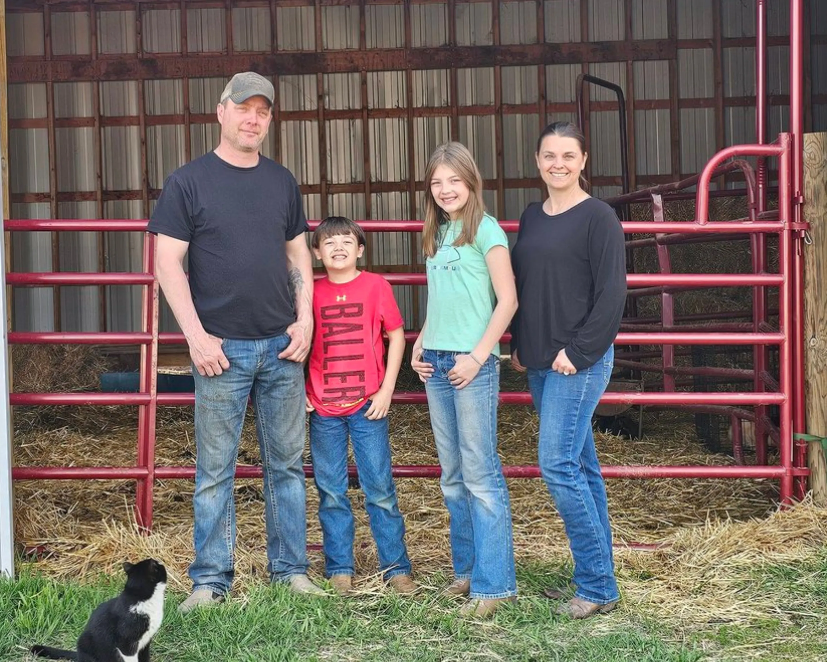 Hartsoch ranch family — Dennis, JoAnna, Makoti, and Waylon standing in front of the barn in North Dakota