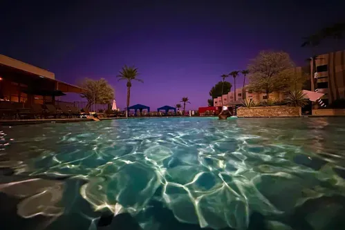 Experience nighttime serenity at the resort pool, only a short 100-yard stroll from your villa.