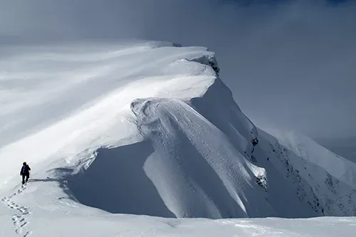 Matthew Storer hiking on a mountain in Poland during deep winter