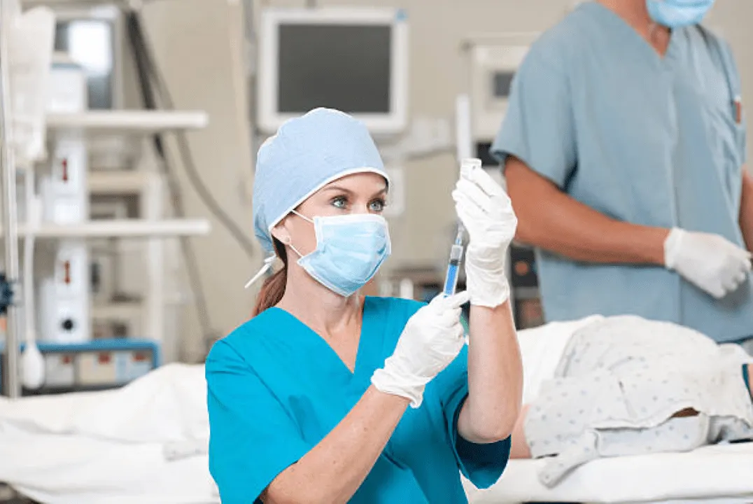 female anesthesiologist with syringe 