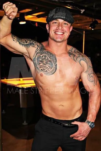 Male Dancer with Huge Smile, Shirtless with Tribal Tattoos on Shoulders, Black Slacks, and Flat Cap