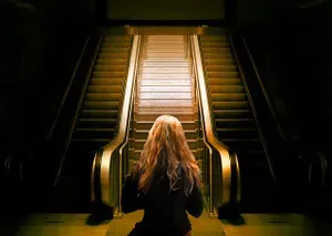 woman looking at escalator to elevate her mindset