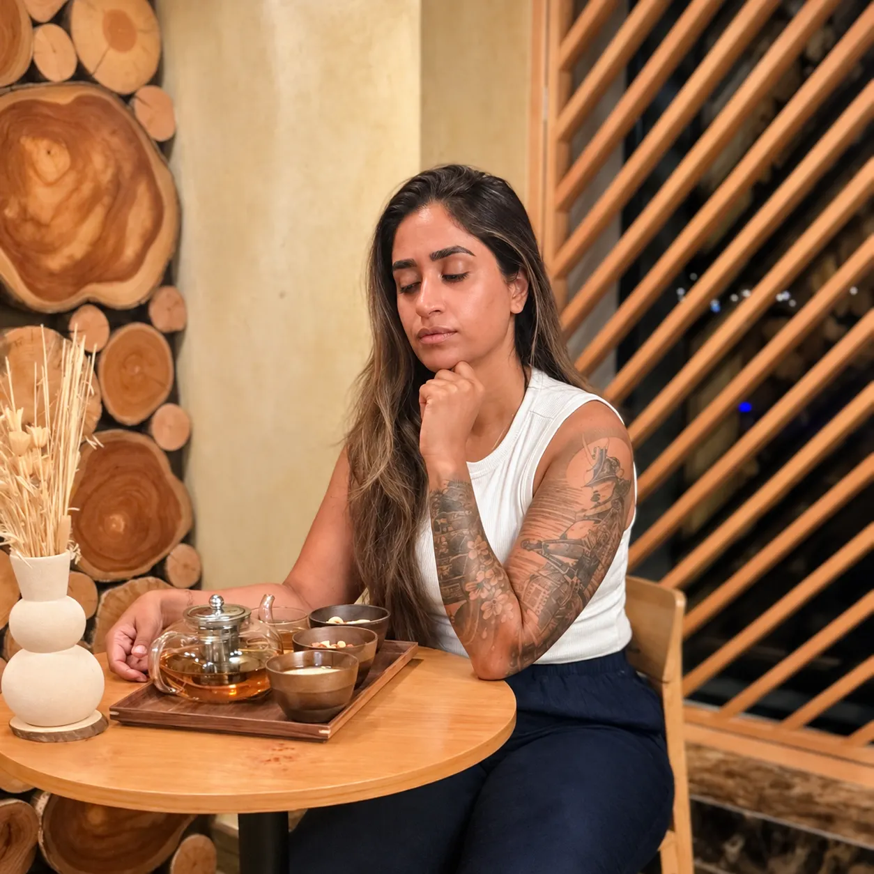 Portrait of Gurmeet Ranotta seated at a table in a calm, natural setting