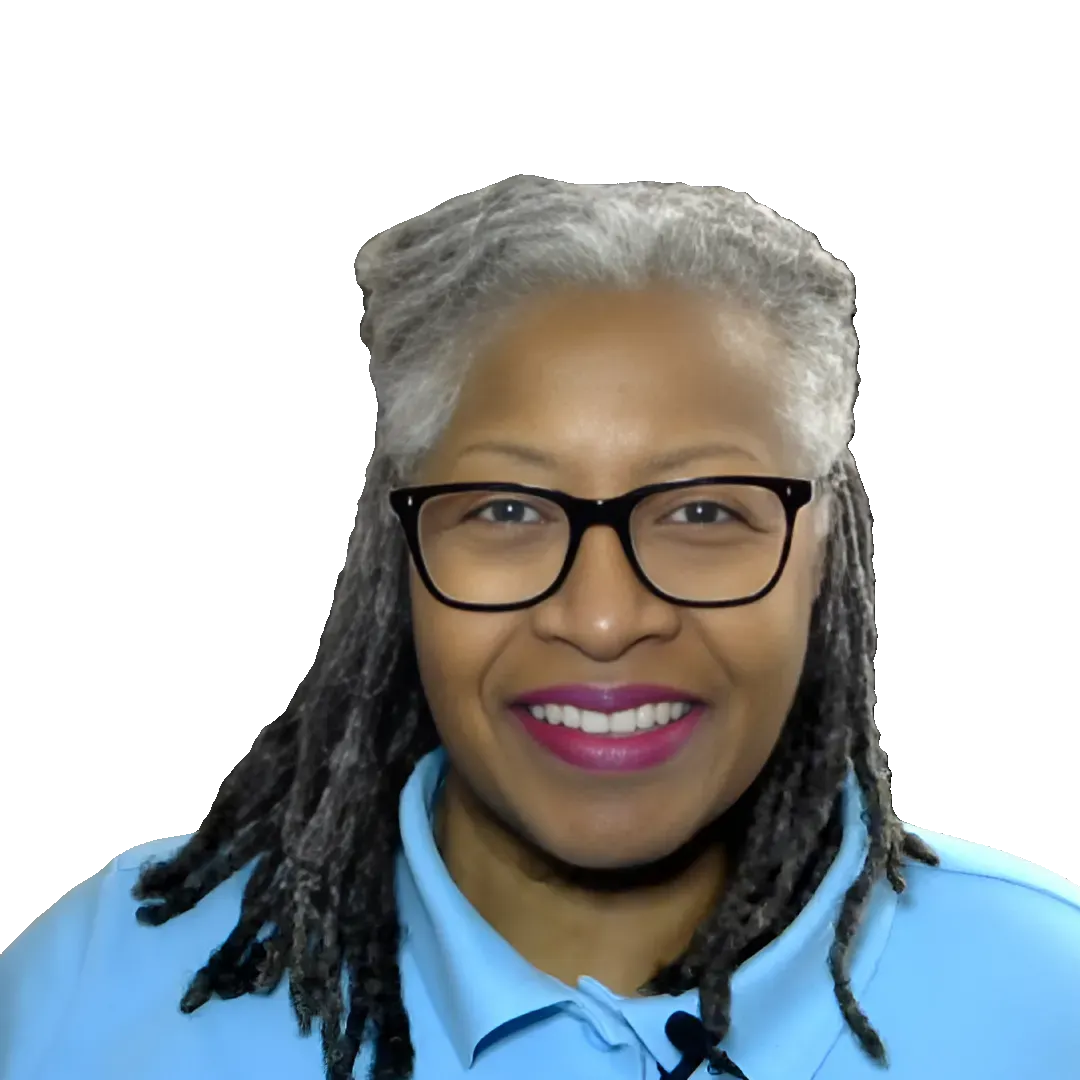 Professional headshot of Dr. Lisa Singletary, MD, MPH, CWHC, smiling and facing the camera. She wears black-framed glasses and a light blue collared shirt, with silver-gray locs styled neatly around her shoulders. The portrait is isolated on a transparent background, making it ideal for wellness branding, health education websites, speaker profiles, webinars, and professional marketing materials.