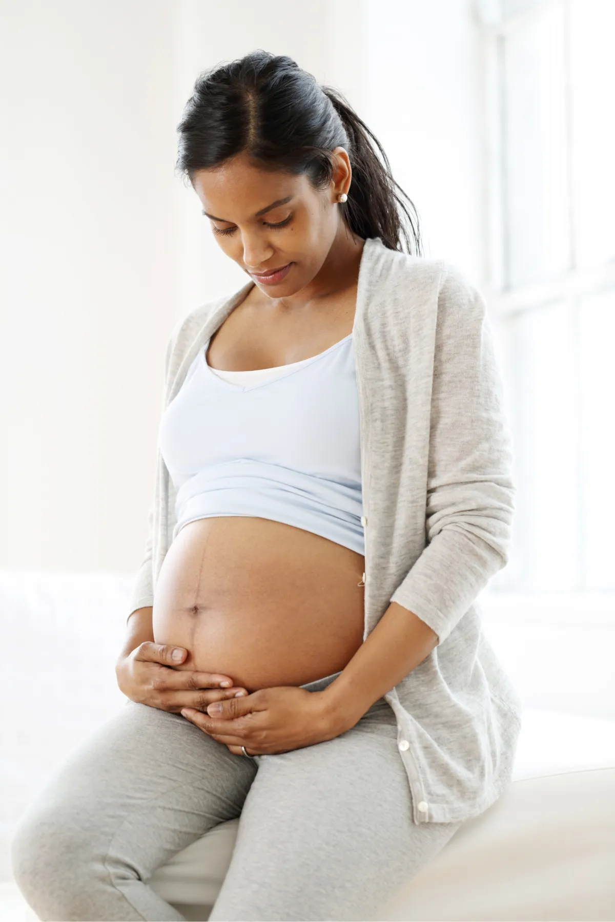 pregnant woman holding her belly