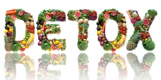 The word "DETOX" spelled out using lots of various fruits and vegetables.