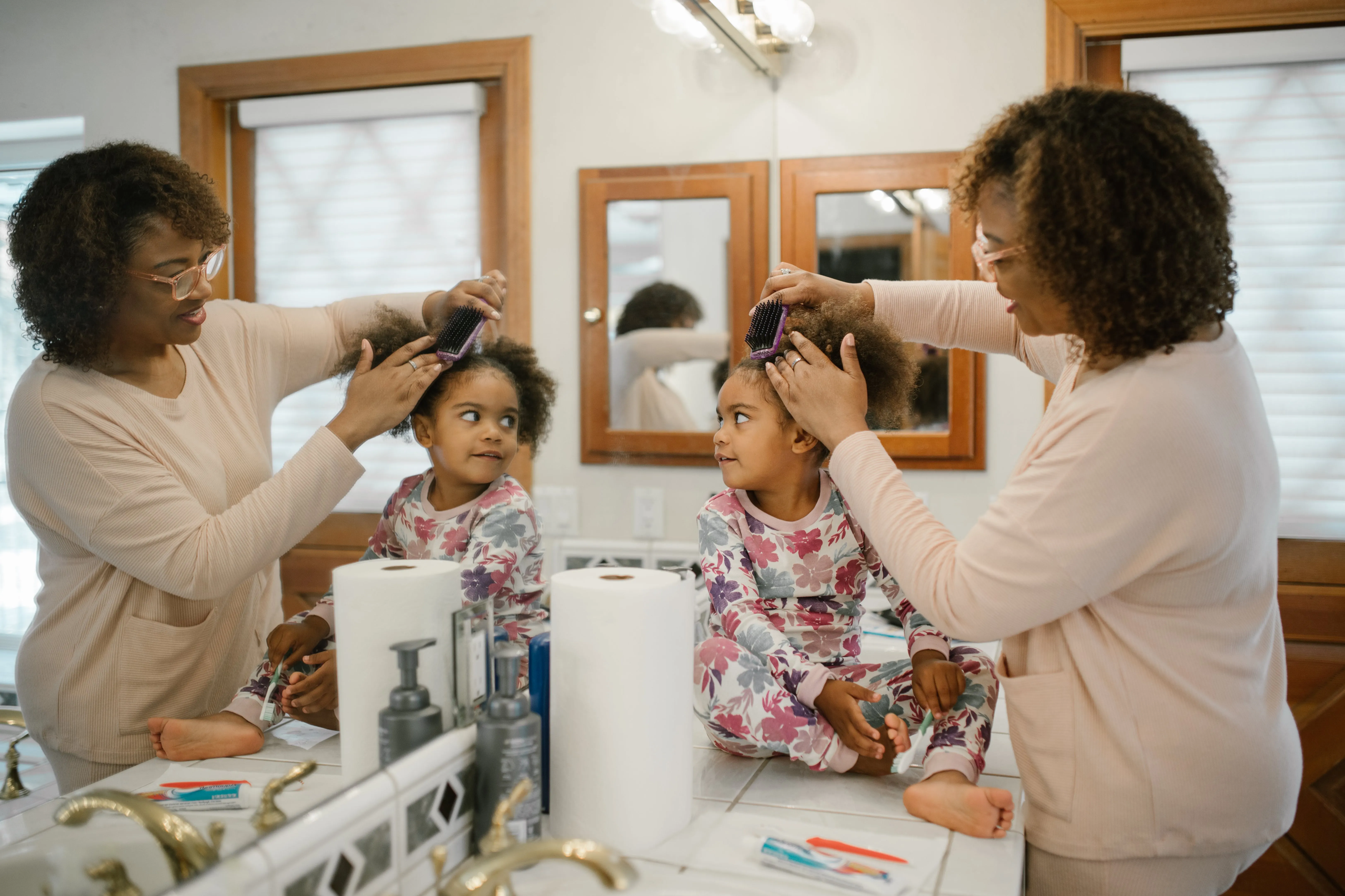 Grandma brushing Granddaughters Afro Hair