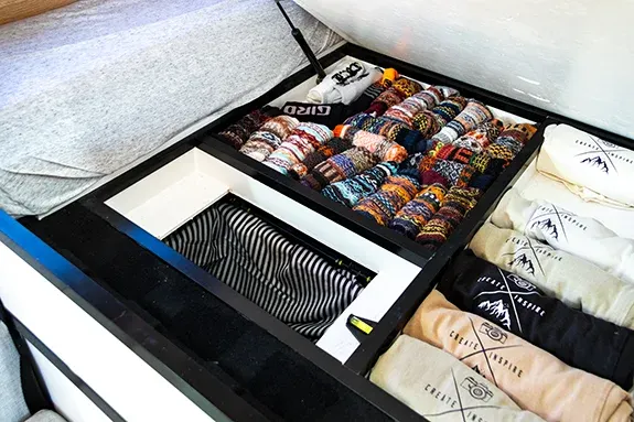 campervan under-bed storage compartments with built-in laundry chute for van life travel