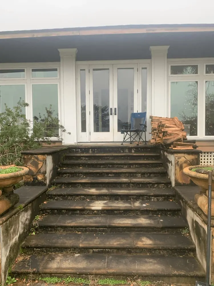 <alt=“Before stone stair and entryway cleaning in Theodore, Mobile County, Alabama showing dark buildup and stained residential steps leading to home entrance.”>