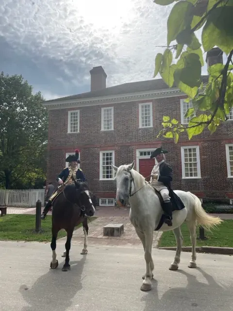 Colonial Williamsburg's Mark Schneider as Lafayette and Ron Carnegie as George Washington on horseback in front of the George Wythe House
