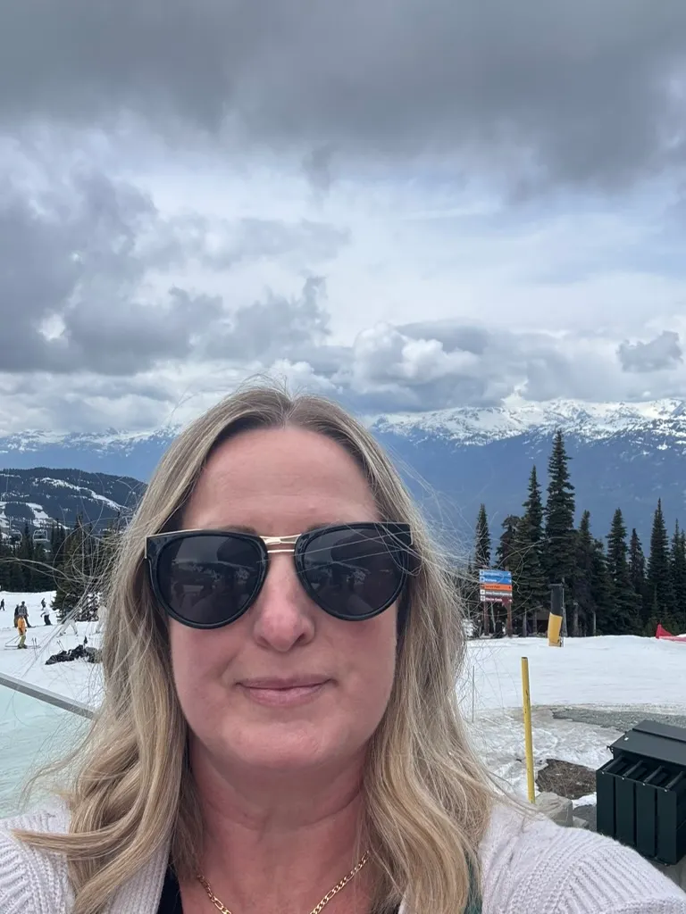Diane Rolston in Whistler with snowy peaks behind her