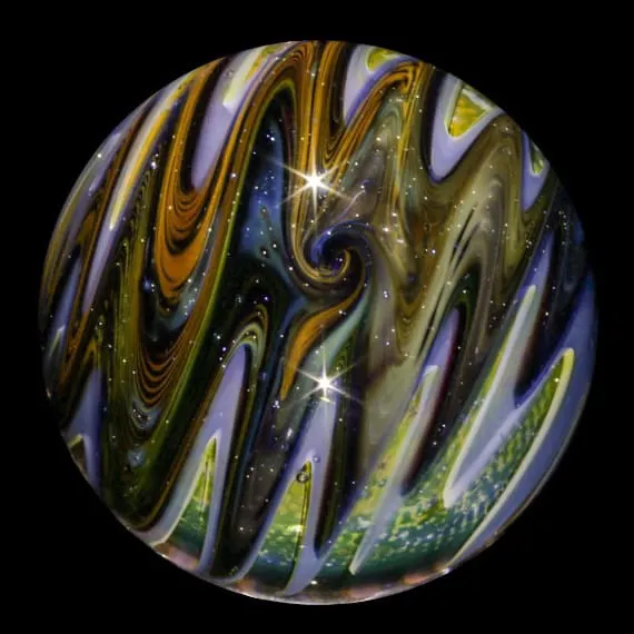 up close image of a glass marble being formed by a torch