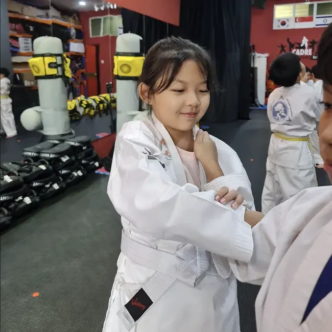 Kids 9 to 13 Year Old practising grappling skills during a kids class at CADRE Academy