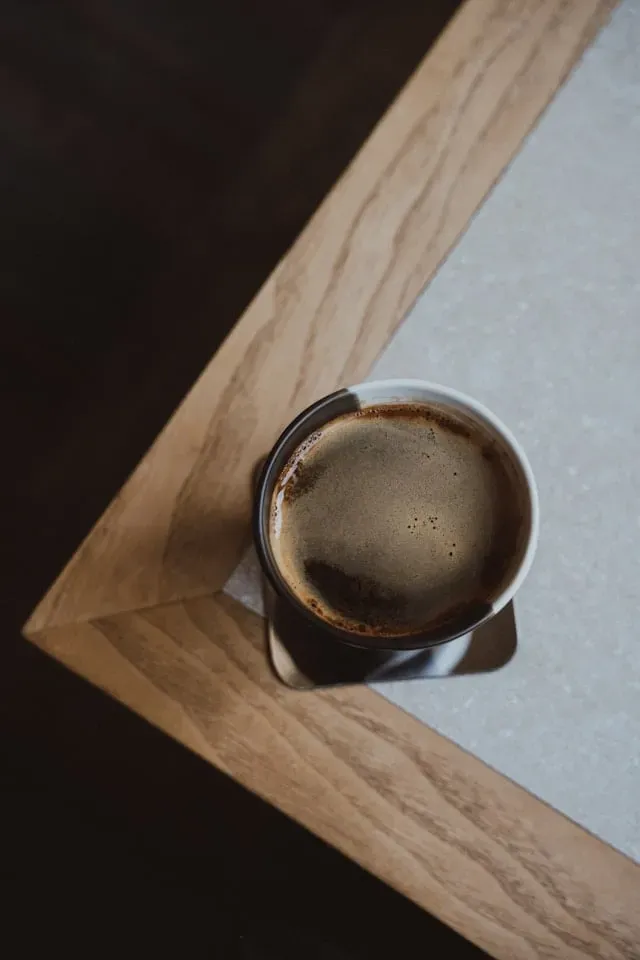 single cup of coffee on a desk