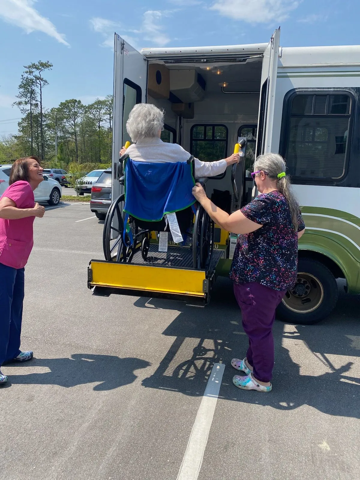 Woman in a wheel chair being loaded into a wheelchair accesable van