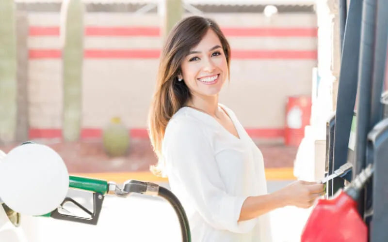 Woman saving money at the gas pump
