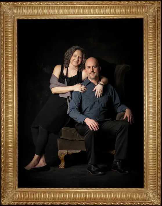 In memoriam of Angie Scott. She is pictured elegantly with her husband while both seated on a chair, her arms wrapped around his shoulders.