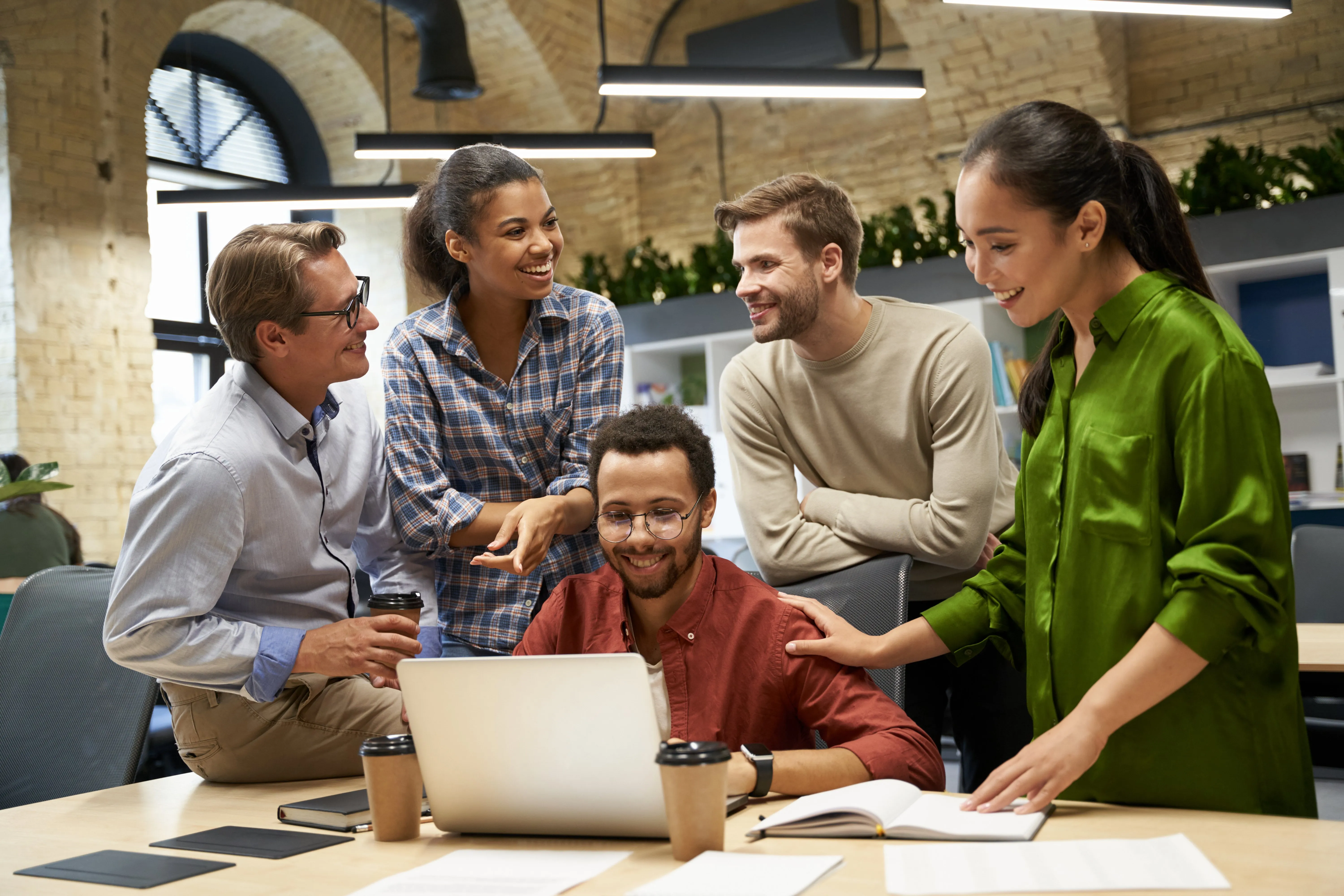 group-of-young-happy-business-people-looking-at-computer