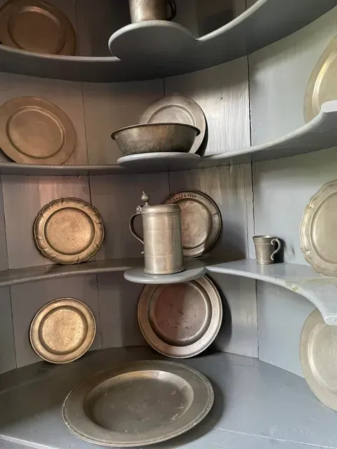 Pewterware on butterfly shelves in Faulcon House at Smith's Fort in Surry Virginia