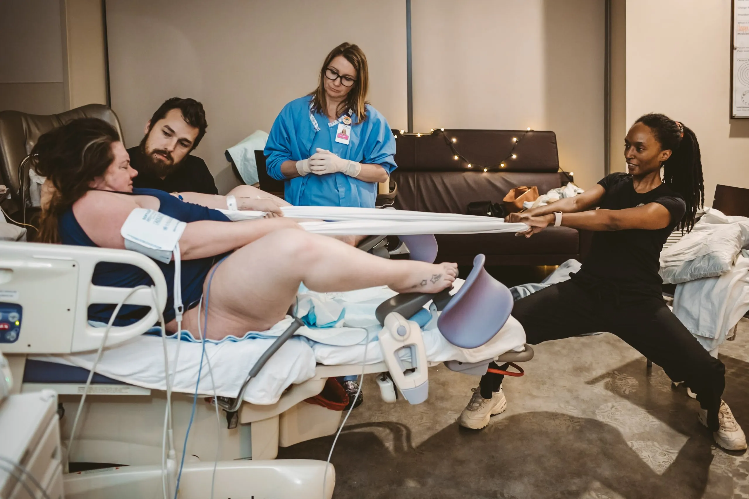 Image of doula assisting client during pushing phase of labor. Photo by Colorado Springs Birth Photographer Danica Donnelly