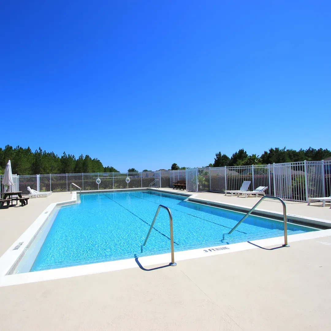 sunbathing in one of the sun loungers or seating areas surrounding the pool