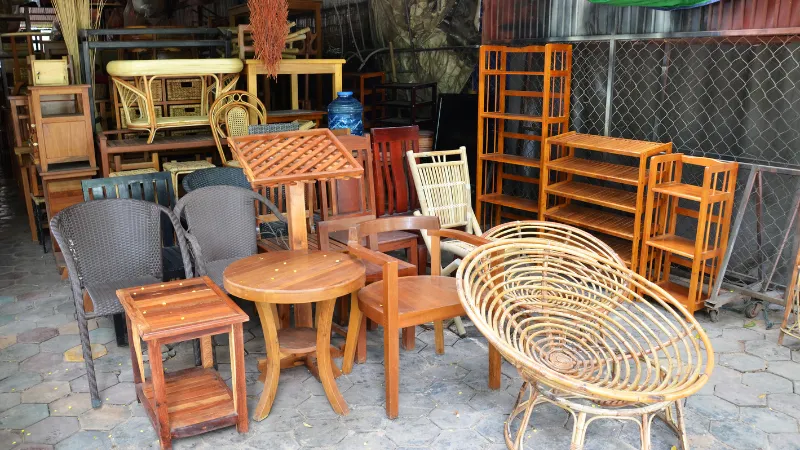 A display of high-quality, gently used furniture pieces, including chairs, tables, and cabinets, available at Thrifty Treasures thrift store in East Lansing, Michigan.