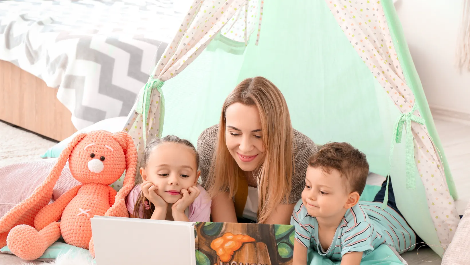 Nanny reading with 3 children
